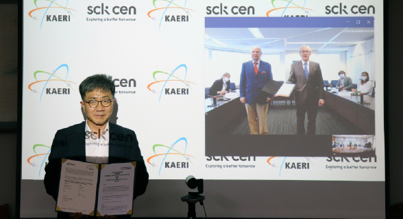 박원석 한국원자력연구원장이 온라인으로 진행한 화상 협약식에서 SCK CEN과의 공동연구 협약서를 들고 기념촬영을 하고 있다